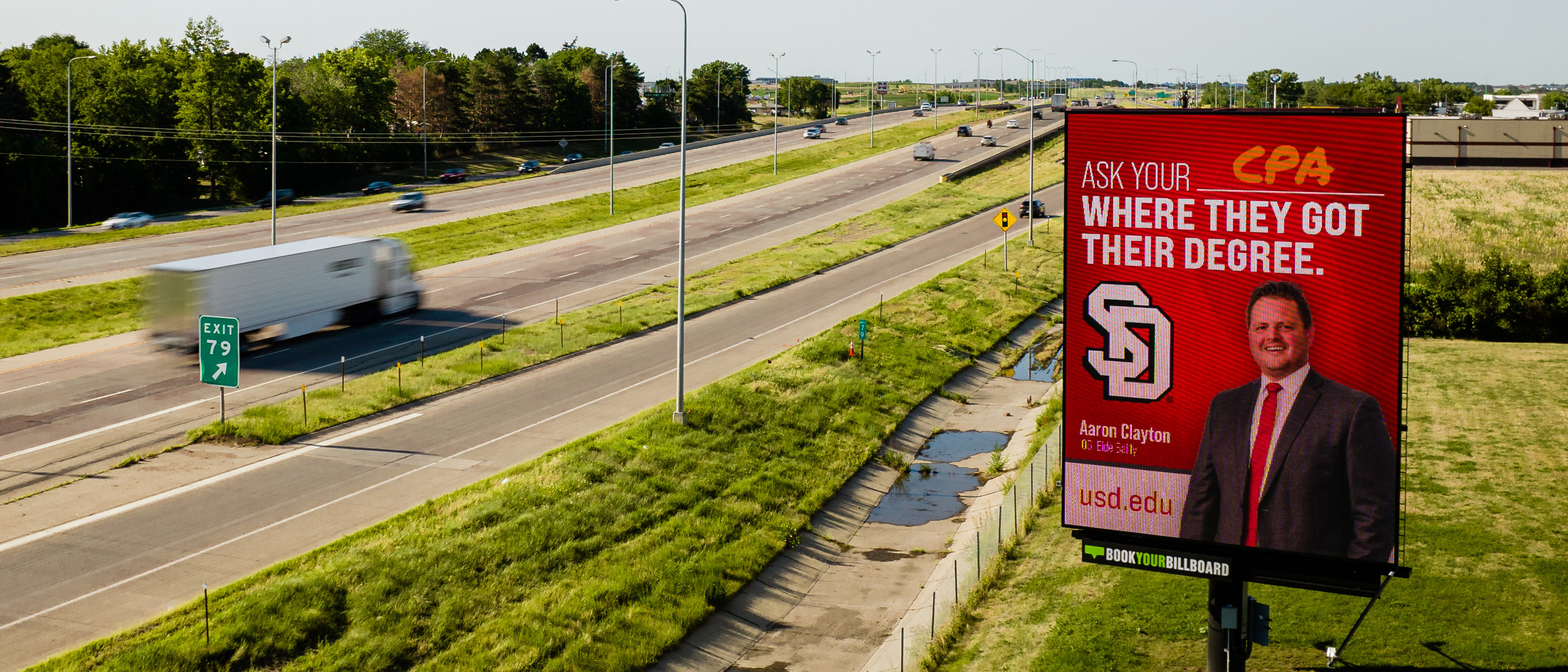 A Book Your Billboard vertical digital display beside the Sioux Falls interstate