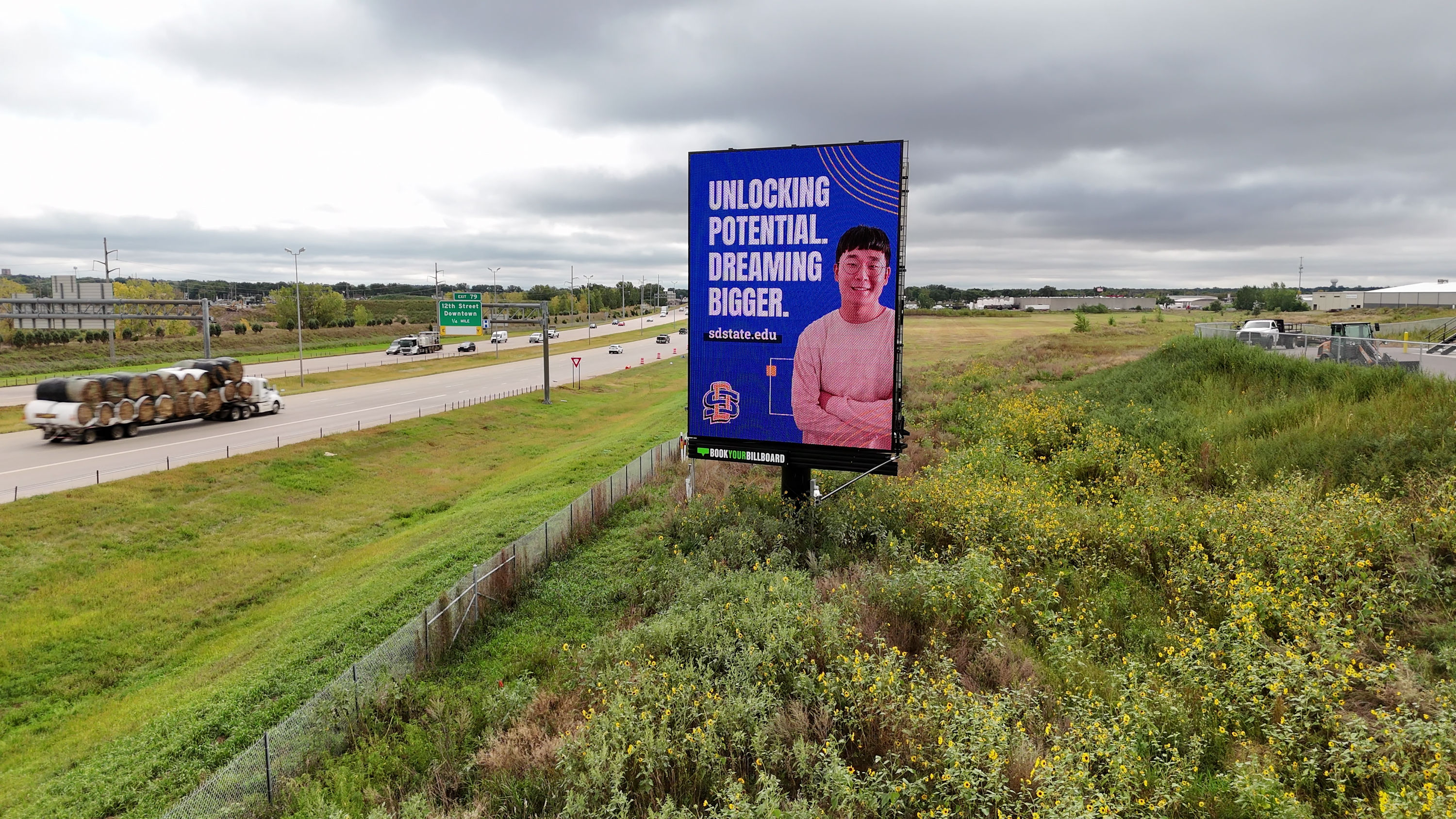 A tall BYB digital billboard alongside the Sioux Falls interstate